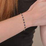 Exquisite garland bracelet featuring vibrant blue sapphires and sparkling diamonds.