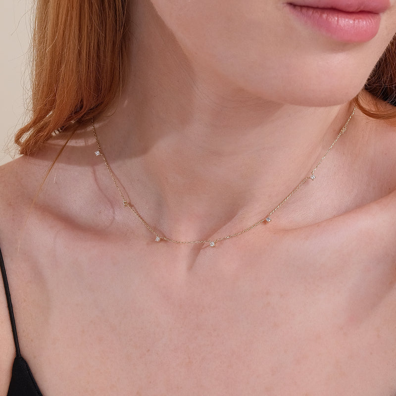 minimalist solid gold necklace with multiple natural diamonds