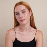 petite solid gold necklace with eye charms in lined natural diamonds and blue sapphire birthstone for her