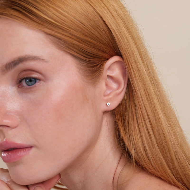 Image of model wearing Natural diamond earring studs with 4-prong setting in solid gold.