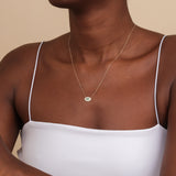 marquise emerald evil eye necklace with natural emerald and lined diamonds