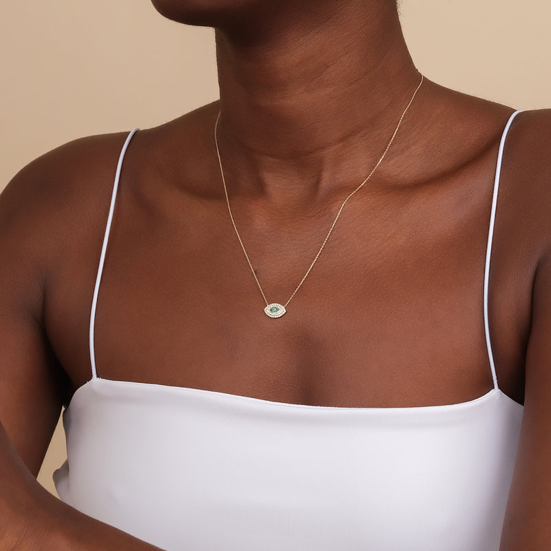 marquise emerald evil eye necklace with natural emerald and lined diamonds