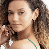 petite emerald earring charm on a diamond huggie