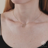 dainty necklace in solid gold with diamond cross pendant