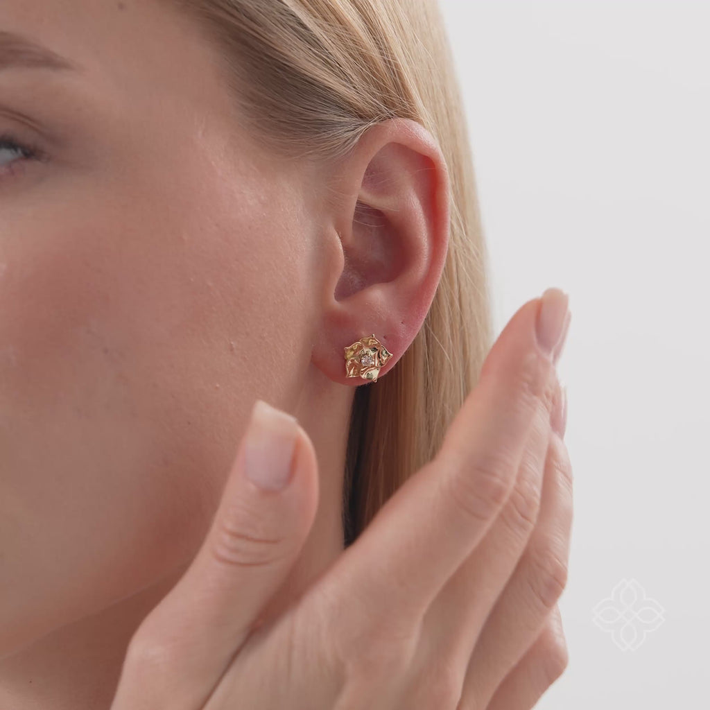 Vexa Infuse your style with the elegant rhythm and timeless beauty of our Gold Floral Diamond Accent Studs. This exquisite pair is meticulously crafted in lustrous solid gold, showcasing a graceful multi-petal flower motif with a highly polished finish. A