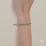 Diamond and emerald tennis bracelet with a unique garland design
