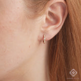 video close up of thin diamond lined pear shape hoop earring