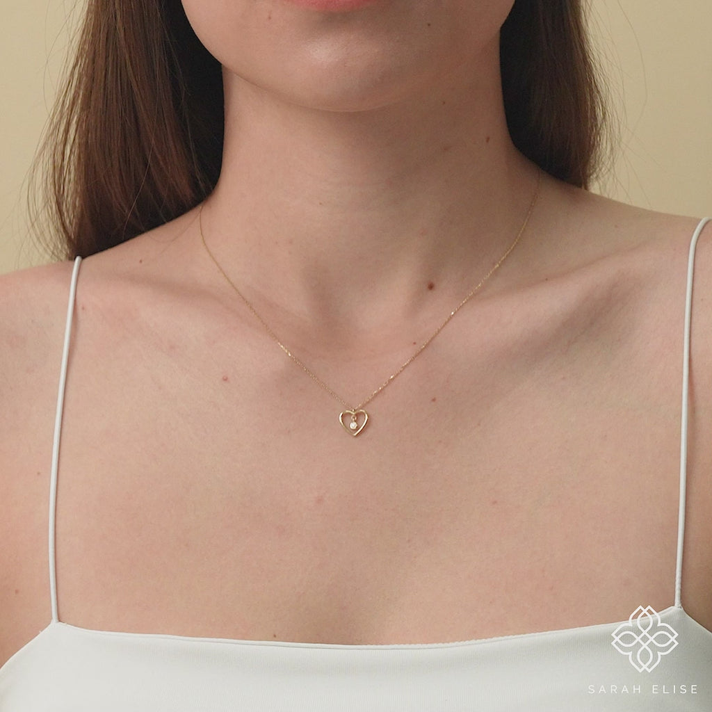 solid gold heart outline with single diamond bezel necklace