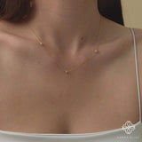 Three-ball necklace with pave diamonds in 14k gold.