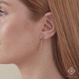 Video close up of april birthstone white clear diamond stud with dangling cuban chain in 14k solid gold