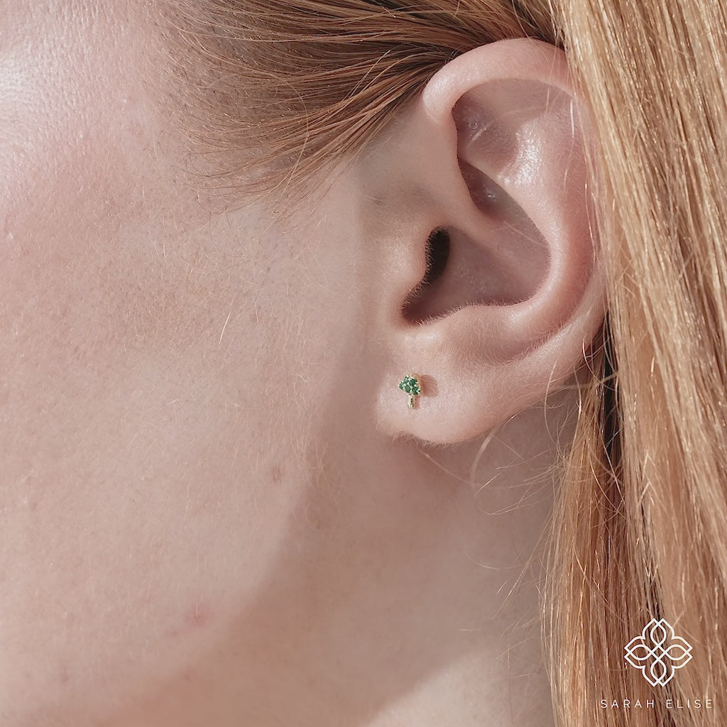 Video close up of tiny dainty mushroom stud earrings in 14k solid gold. 