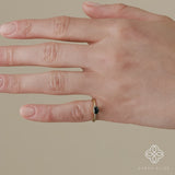 twisted solid gold ring with oval cut teal blue sapphire 