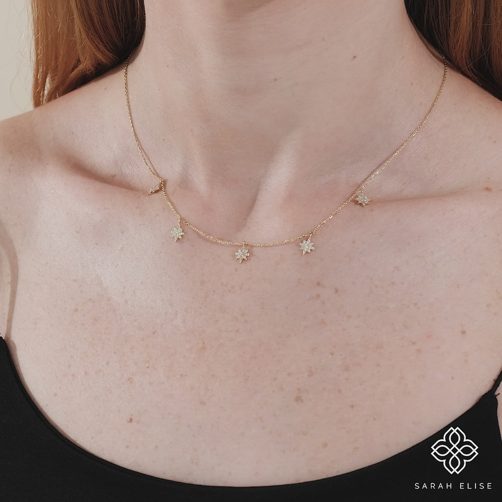 minimalist solid gold necklace with hanging paved diamond starburst charms for her