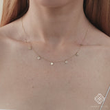 Delicate chain necklace with alternating smooth and diamond-encrusted coin charms.