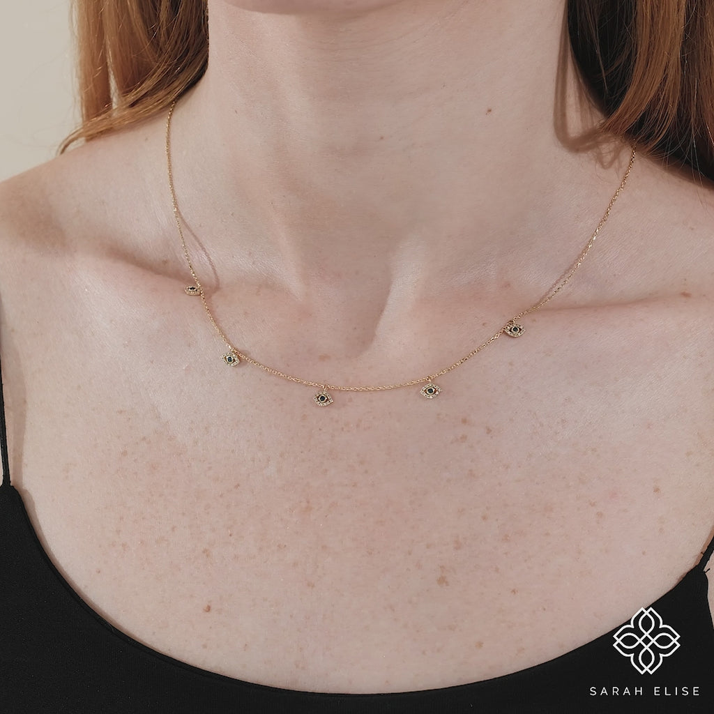 dainty eye charm necklace with diamonds and blue sapphire 