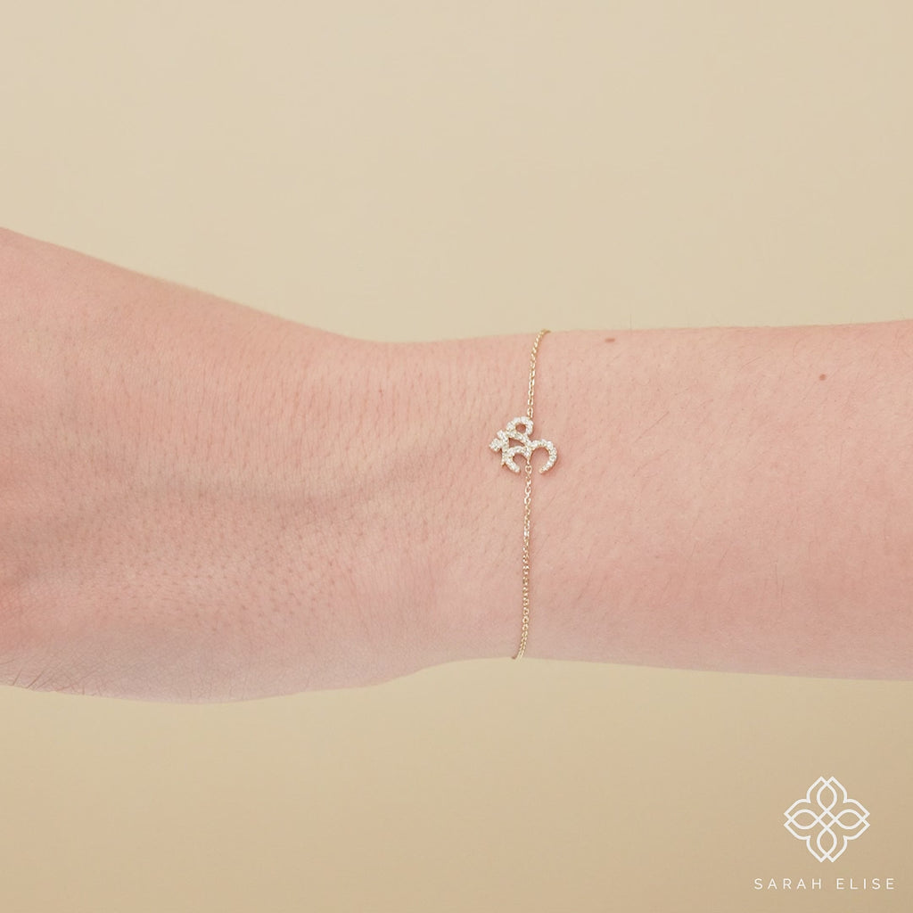  Bracelet featuring the sacred OM symbol with diamonds, representing inner peace.