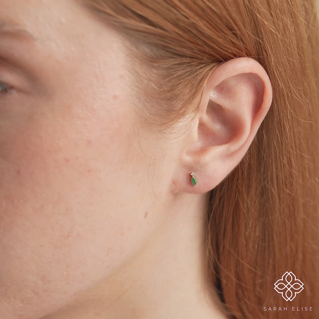 Video close up of green emerald marquise cut stone and April birthstone natural diamond in 14k solid gold gift for her. 