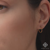 Video close up of thin colorful rainbow hoop earring in solid 14k gold