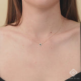 Gold and black enamel heart necklace with sparkling diamonds.