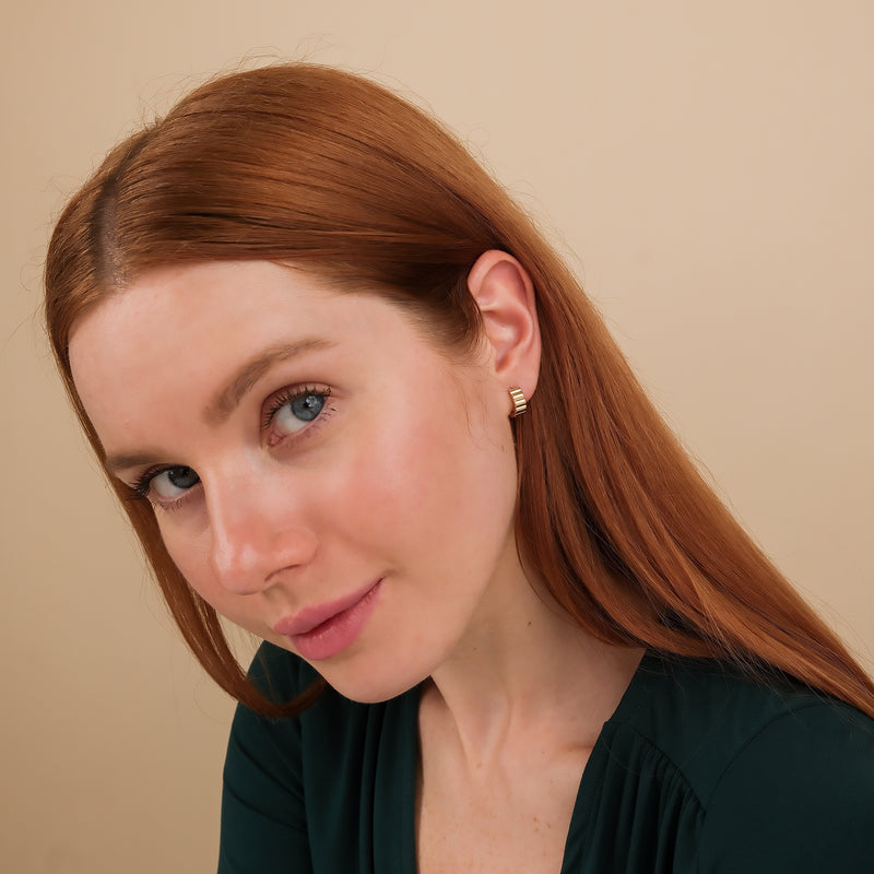 Model wears elegant 14k Solid Gold Grosgrain Huggies