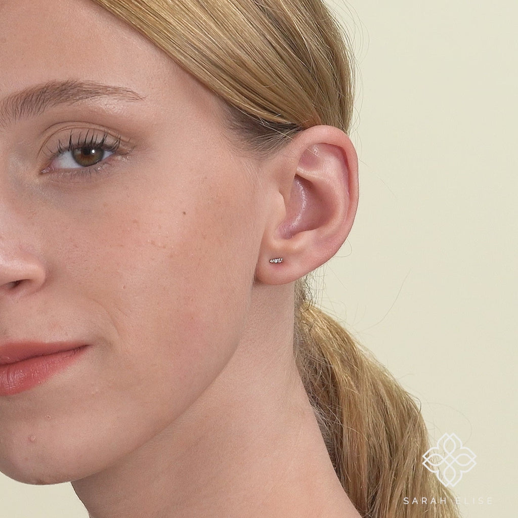 model wears Dainty Diamond and Gold spike stud Earrings