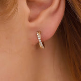 close up image of cross shape hoop earring