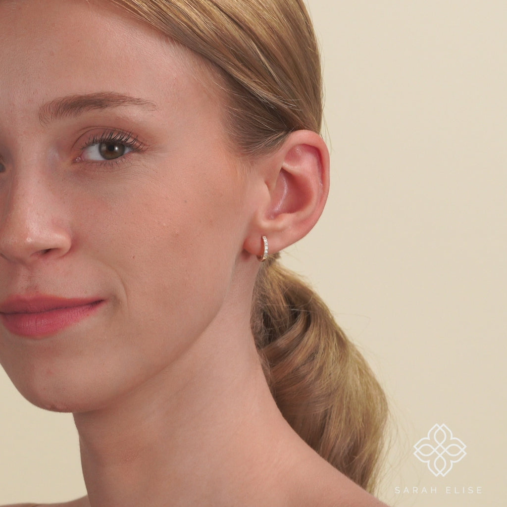 Video close up of solid 14k gold diamond lined hoop huggie