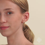 Video close up of solid 14k gold diamond lined hoop huggie