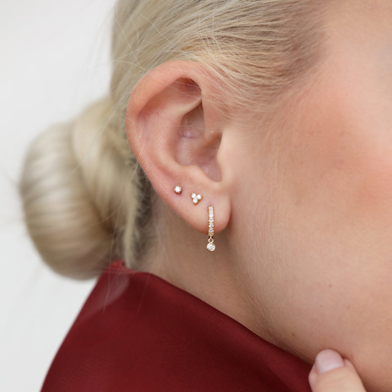 Model wears dainty Diamond cluster Studs and Dangling Hoop