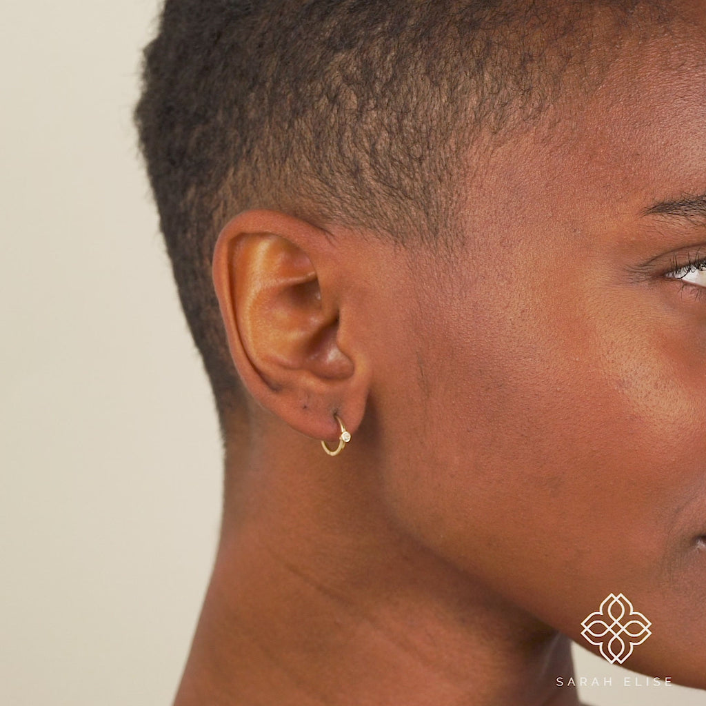 Video close up of Handmade single Natural Aquamarine Huggies in solid 14k gold for her