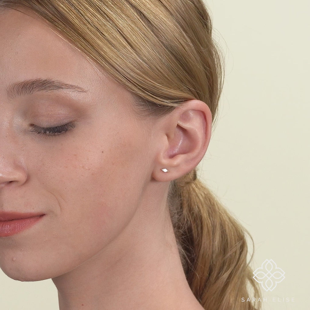 Video close up of model wearing Petite marquise Diamond 13k solid Gold Studs