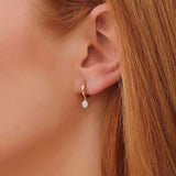 Model wears Pave Diamond Dangling Hoop Earrings in solid 14k gold