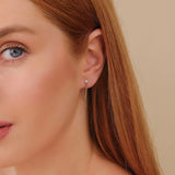 Model wears ethically sourced fine jewelry single stud diamond with hanging cuban chain in 14k solid gold