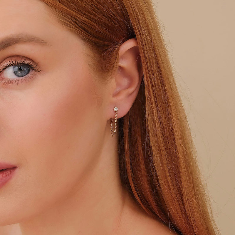 Model wears ethically sourced fine jewelry single stud diamond with hanging cuban chain in 14k solid gold