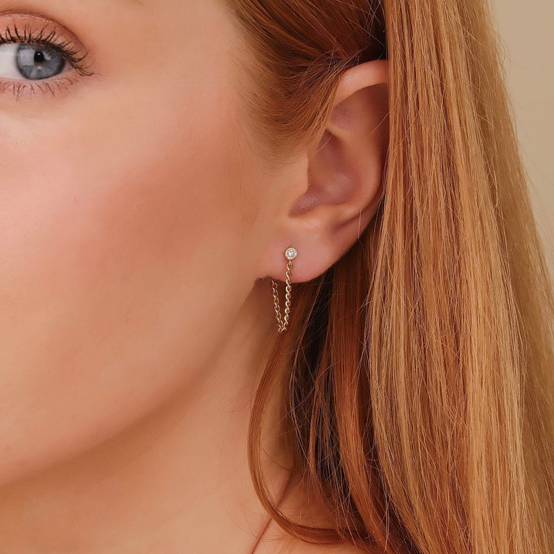 Model wears 14k Solid Gold Bezel Diamond stud earring with hanging cuban chain link 