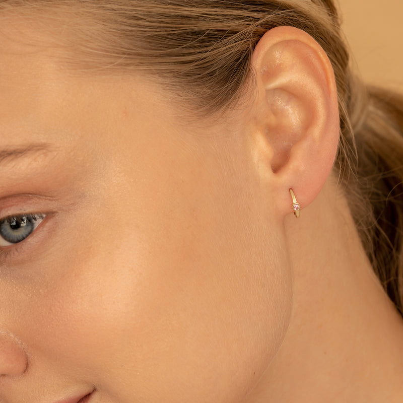 Model wears Bezel Setting Tourmaline October Huggies