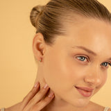 Minimalistic Handmade single Emerald birthstone Huggies in solid gold