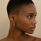 Model wears Diamond and Sapphire Evil Eye huggie Earrings