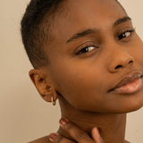 Model wears dainty Solid Gold multi Diamond mini hoop earring