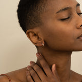 Model wears Minimalist Diamond Earrings with three diamonds