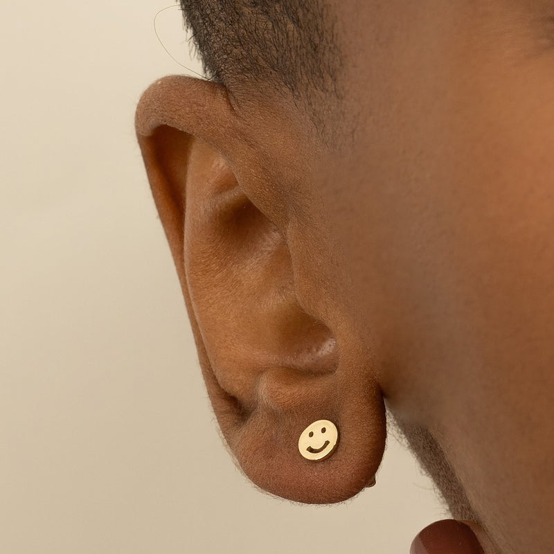 Model wears Dainty Gold Smiley Stud earrings