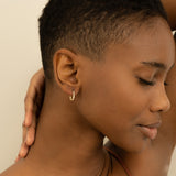 Model wears Solid 14k Gold Thin Diamond Hoop earrings