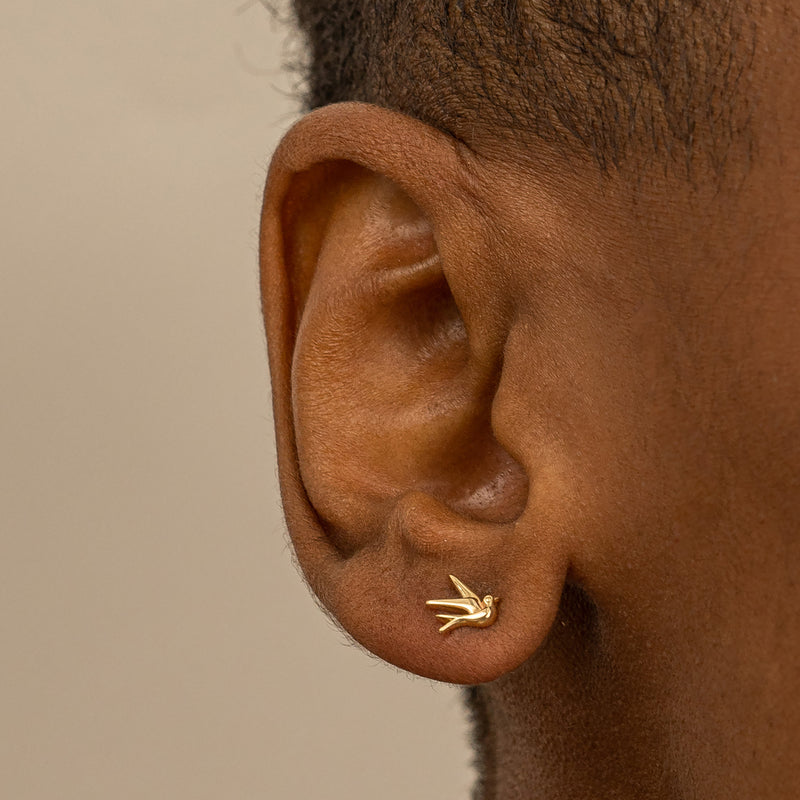 Model wears Minimalist Bird Earring studs