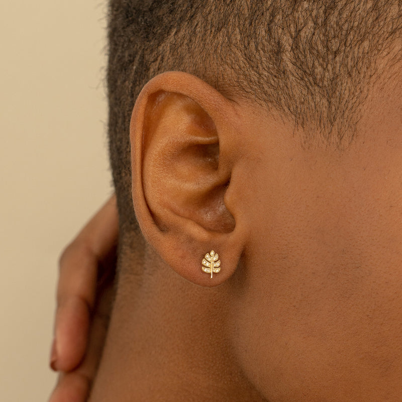 Model wears solid 14k gold Handmade Palm Leaf Diamond Stud earring