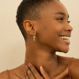 Model wears Love Hoop Earrings with Paved Diamonds