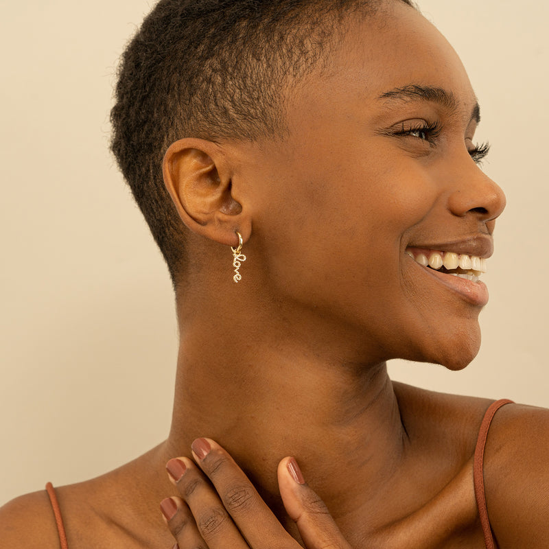 Model wears Love Hoop Earrings with Paved Diamonds