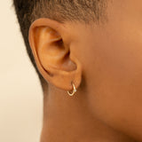 Model wears Simplistic natural Diamond April birthstone Huggies for her