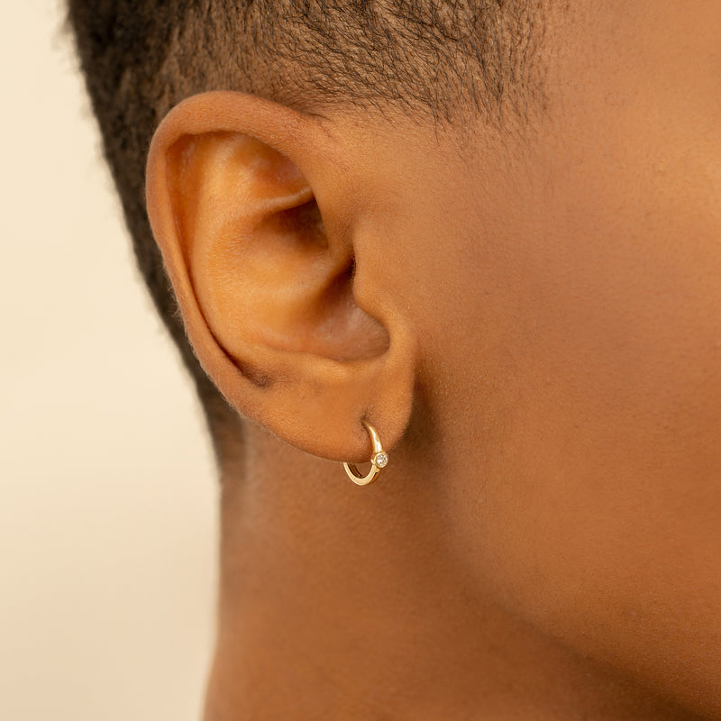 Model wears Simplistic natural Diamond April birthstone Huggies for her