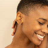 Model wears Tiny Gold Diamond Huggie Earrings