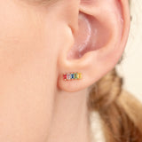 Model wears dainty colorful Natural Rainbow Sapphire bar Studs